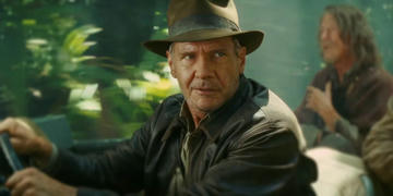 Harrison Ford as Indiana Jones, escpaing some Nazis in a lush jungle.