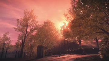 A shot from the game depicting a deep pink sunset with godrays shining through trees over a traditional british red phone box by the side of a road.