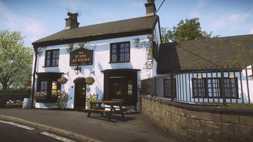 A shot from the game depicting a traditional British village pub named The Stars At Night, with white plastered walls and pretty hanging baskets.